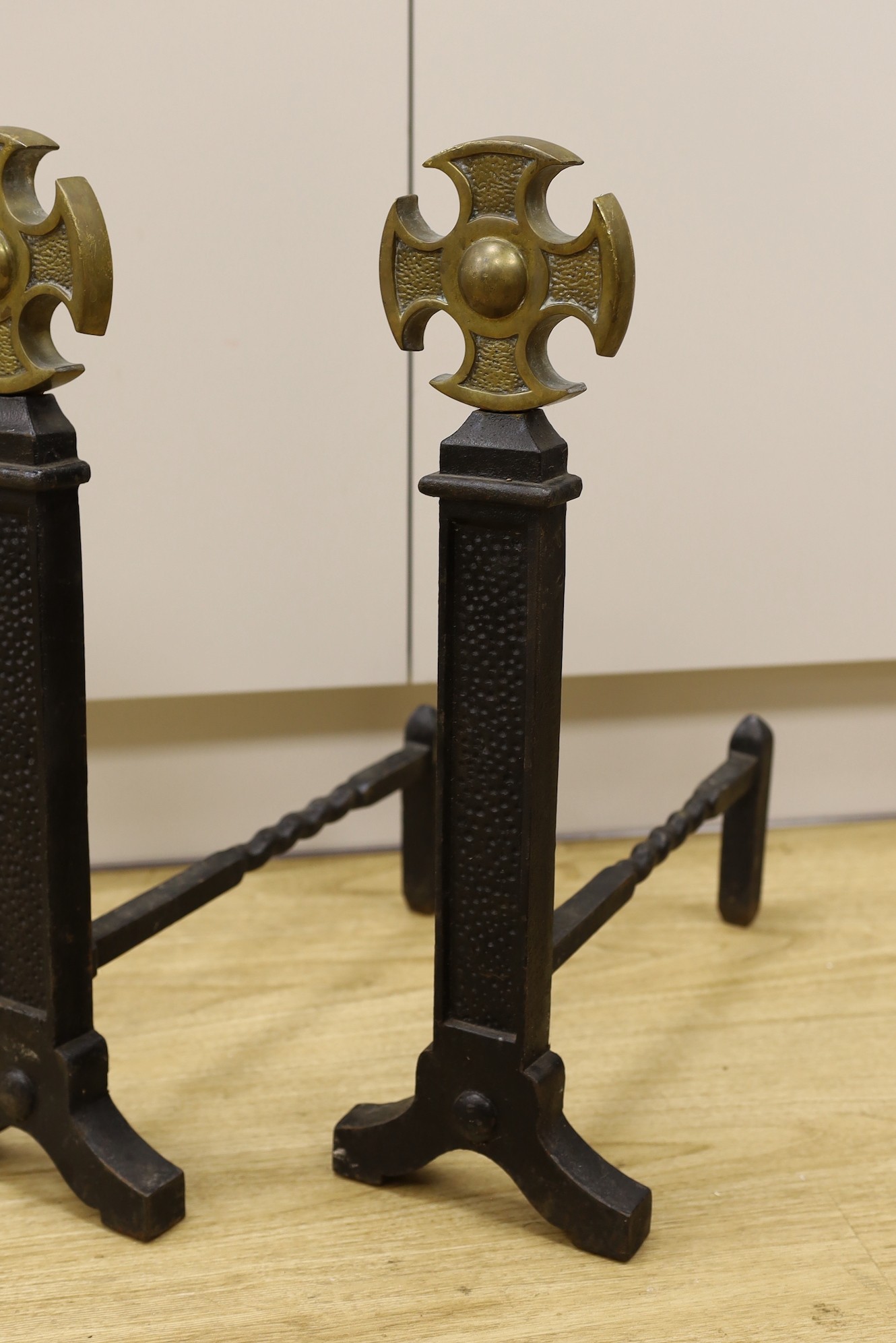A pair of Victorian cast iron and brass fire dogs, 54cm tall